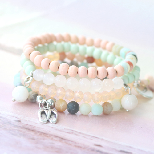 Beautiful semi-precious stone bracelets in soft colours mixed with wooden beads, cork, tassels and DQ metal charms.