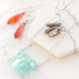 Earrings and necklaces with drop shaped natural stone beads and aura quartz crystal