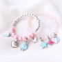 Girly jewellery with cheerful metal charms and soft colours