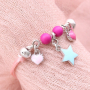Girly jewellery with cheerful metal charms and soft colours