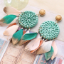 Festival jewellery inspiration with feathers and rattan pendants