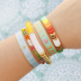 Inspiration for bracelets with acrylic beads, faceted beads and ribbon with text