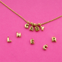Create playful necklaces with stainless steel charms and letters